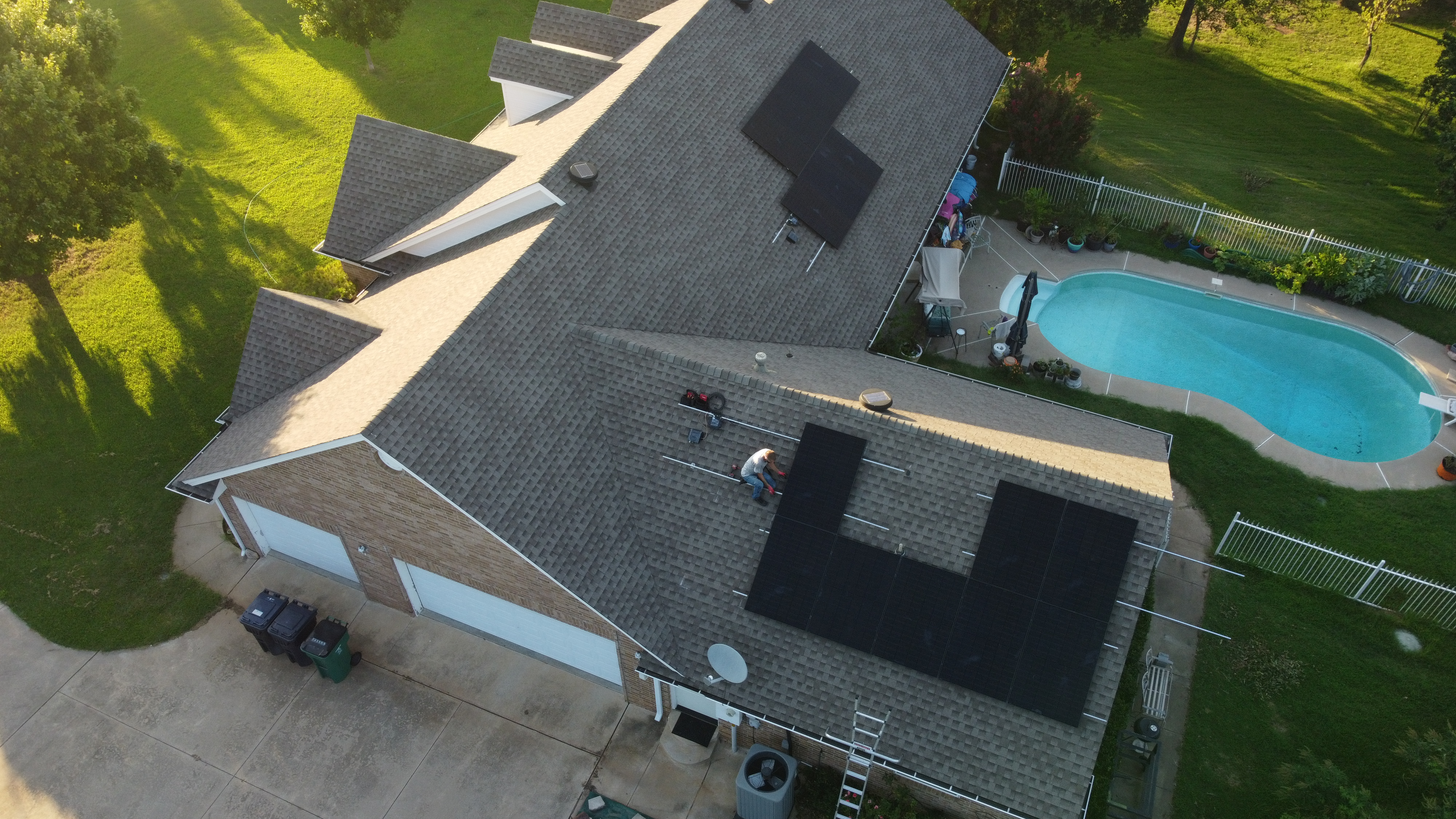 Solar installation crew working at golden hour on Oklahoma home