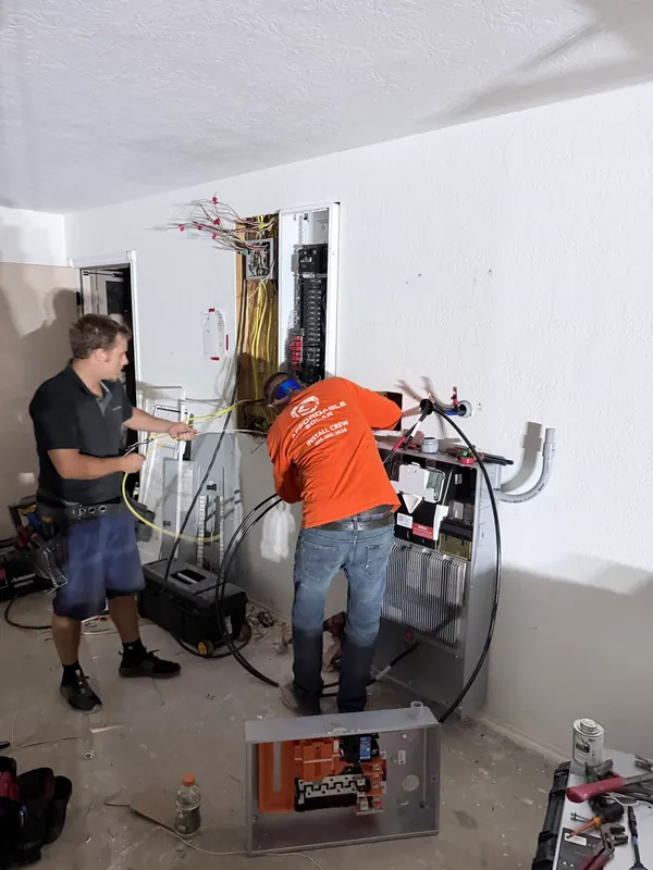 Affordable Solar crew servicing home electrical equipment